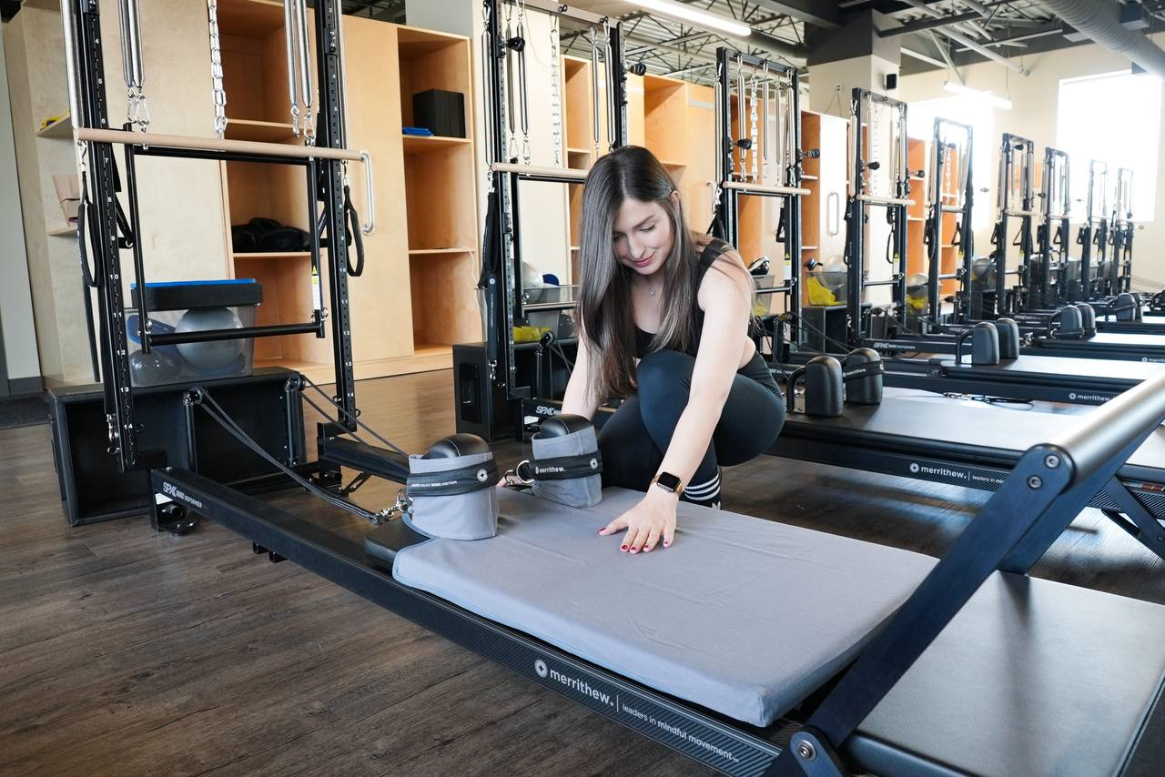 Model placing Reform Wear cover on reformer
